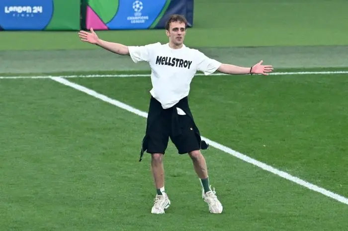 A pitch invader runs on the pitch during the UEFA Champions League final football match between Borussia Dortmund and Real Madrid, at Wembley stadium, in London, on June 1, 2024. (Photo by JUSTIN TALLIS / AFP)
