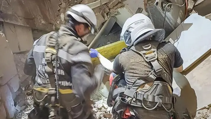 Einsatzkräfte der Wiener Berufsfeuerwehr in einem Trümmerhaufen eines eingestürzten Gebäudes.