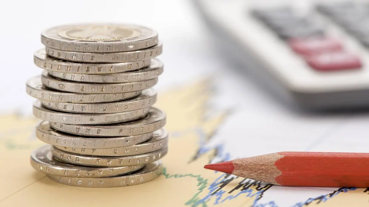 stacked euro coins and calculator laying on financial business chart of stock market stacked euro coins and calculator laying on financial business chart Copyright: xZoonar.com/wolfilserx 11959252