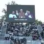 A screen flashes the news of new Pope Leo XIV, during the second round match between Italys' Fabio Fognini and  Britain's Jacob Fearnley at the Italian Open tennis tournament, Thursday. May 8, 2025, in Rome. (Alfredo Falcone/LaPresse via AP)