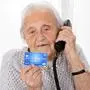 Portrait Of Senior Woman Giving Credit Card Details On The Phone