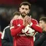 Manchester United's Bruno Fernandes celebrates with the ball in his hands after the Europa League soccer match between Manchester United and Real Sociedad at Old Trafford stadium in Manchester, England, Thursday, March 13, 2025 . (AP Photo/Dave Thompson)