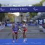 Spain's Elena Congost, right, wins the bronze medal in the women's marathon T12 at the 2024 Paralympics, Sunday, Sept. 8, 2024, in Paris, France. (AP Photo/Thibault Camus)