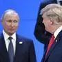 US President Donald Trump (R) looks at Russia's President Vladimir Putin as they take their places for a family photo, during the G20 Leaders' Summit in Buenos Aires, on November 30, 2018. - Global leaders gather in the Argentine capital for a two-day G20 summit beginning on Friday likely to be dominated by simmering international tensions over trade. (Photo by Alexander NEMENOV / AFP)