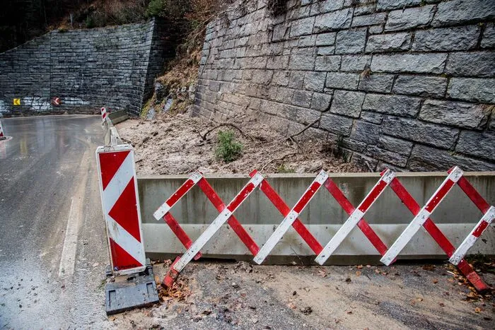 Da sich immer wieder Schuttmaterial löste, musst die Straße gesperrt werden. Die bergseitige Fahrbahn ist mit Betonleitwänden abgesichert.