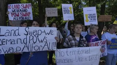People attend a rally ahead to the meeting between U.S. President Donald Trump and Russian President Vladimir Putin, during a rally in front of the U.S. Embassy in Kyiv, Ukraine, Friday, Aug. 15, 2025. (AP Photo/Efrem Lukatsky)