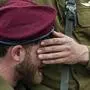 Israeli soldiers mourners in grief during the funeral of Israeli solider Staff sergeant David Sasson, in Netanya, Israel, Thursday, March 7, 2024. Sasson, 21, was killed during Israel's ground operation in the Gaza Strip, where the Israeli army has been battling Palestinian militants in the war ignited by Hamas' Oct. 7 attack into Israel. (AP Photo/Ariel Schalit)