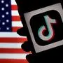 (FILES) In this file illustration photo taken on August 3, 2020  the social media application logo TikTok is displayed on the screen of an iPhone on an American flag background in Arlington, Virginia. - The US is expanding its China-targeted Clean Network program to include Chinese-made cellphone apps and cloud computing services that it claims are security risks, Secretary of State Mike Pompeo announced on August 5, 2020. (Photo by Olivier DOULIERY / AFP)
