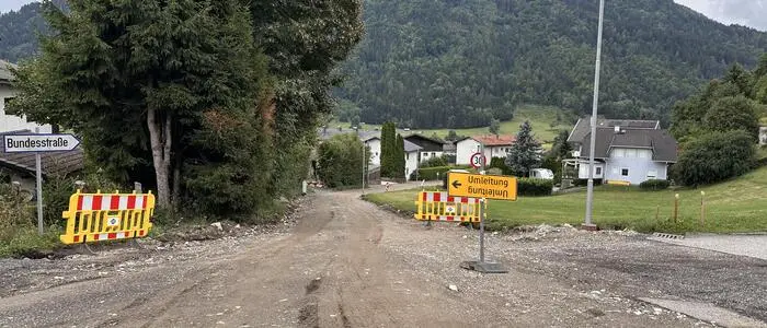 Eine Gemeindestraße, die für die Asphaltierung vorbereitet wurde. Man sieht ein Umleitungsschild