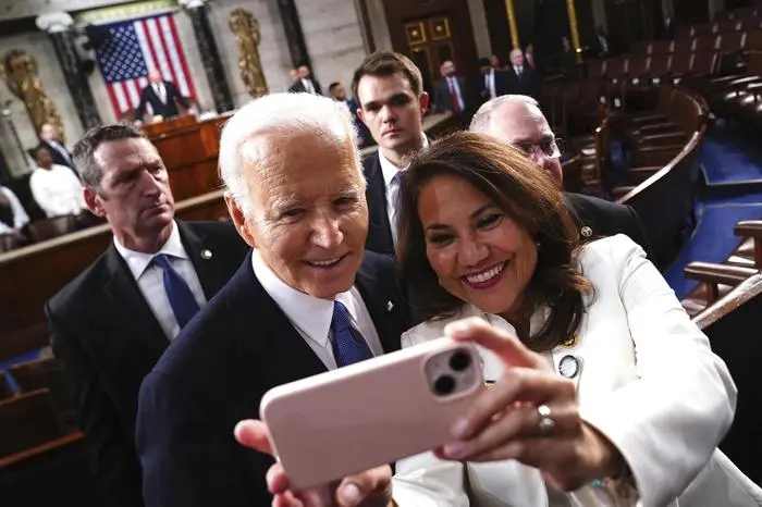 President Joe Biden, left, takes a photo with Rep. Veronica Escobar, D-Texas, after delivering the State of the Union address to a joint session of Congress at the Capitol, Thursday, March 7, 2024, in Washington. (Shawn Thew/Pool via AP)