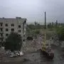Ukrainian emergency workers labor to pull people out of the rubble after a Russian rocket attack smashed into apartment buildings, in Chasiv Yar, Donetsk region, eastern Ukraine, Monday, July 11, 2022. The attack killed at least 15 people and more than 20 people were believed still trapped according to officials. (AP Photo/Nariman El-Mofty)