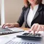 Asian female accountant or banker making calculations. Savings, finances and economy concept.