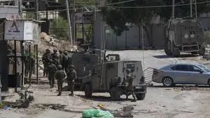 Members of Israeli forces patrol a street during a military operation in the West Bank refugee camp of Al-Faraa, Wednesday, Aug. 28, 2024. (AP Photo/Nasser Nasser)