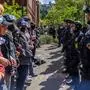 TOPSHOT - Pro-Palestinian students and activists face police officers after protesters were evicted from the library on campus earlier in the day at Portland State University in Portland, Oregon on May 2, 2024. olice deployed a heavy presence on US university campuses after forcibly clearing away some weeks-long protests against Israel's war with Hamas. (Photo by John Rudoff / AFP)