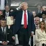 US President Donald Trump (C) stands and salutes, flanked by US Secretary of Defense Pete Hegseth and US First Lady Melania Trump, as they watch the Army 250th Anniversary Parade from the Ellipse in Washington, DC on June 14, 2025. Trump's long-held dream of a parade will come true as nearly 7,000 troops plus dozens of tanks and helicopters rumble through the capital in an event officially marking the 250th anniversary of the US army which also coincides with President Donald Trump's 79th birthday. (Photo by Mandel NGAN / AFP)