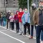 People wait in a queue to receive a swab test for Covid-19 at a walk-in portable testing centre operated by the ambulance service in Dublin, Ireland on March 25, 2021, as the country struggles to reduce the spread of coronavirus. (Photo by Paul Faith / AFP)