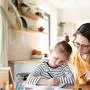 Mother and small daughter learning indoors at home, Corona virus and quarantine concept.