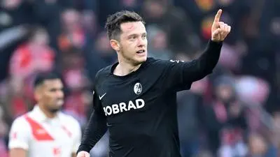 Freiburg's Austrian forward #38 Michael Gregoritsch celebrates scoring the 1-1 goal during the German first division Bundesliga football match between 1 FSV Mainz 05 and SC Freiburg in Mainz, western Germany on March 15, 2025. (Photo by Kirill KUDRYAVTSEV / AFP) / DFL REGULATIONS PROHIBIT ANY USE OF PHOTOGRAPHS AS IMAGE SEQUENCES AND/OR QUASI-VIDEO