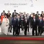 (Front-row) Brazil President Jair Bolsonaro, French President Emmanuel Macron, Indonesia President Joko Widodo, Chinese President Xi Jinping, US President Donald Trump, Saudi Arabia's Crown Prince Salman, Japan Prime Minister Shinxo Abe, Argentine President Mauricio Macri, Russian President Vladimir Putin, Turkish President Recep Tayyip Erdogan, South Korean President Moon Jae-in, South African President Cyril Ramaphosa, Netherlands Prime Minister Mark Rutte, (Second) Spanish Prime Minister Pedro Sanchez, Egypt President Abdel Fattah el-Sisi, President of the European Commission Jean-Claude Juncker, Australia's Prime Minister Scott Morrison, British Prime Minister Theresa May, India Prime Minister Narendra Modi, Canada Prime Minister Justin Trudeau, Italian Prime Minister Giuseppe Conte, European Union President of the European Council Donald Tusk, Senegal President Macky Sall, Chile President Sebastian Pinera and Singapore Prime Minister Lee Hsien Loong and third row's invited guests attend the family photo during the G20 Osaka Summit in Osaka on June 28, 2019. (Photo by Ludovic MARIN / AFP) / ?The erroneous mention[s] appearing in the metadata of this photo by Ludovic MARIN has been modified in AFP systems in the following manner: [Crown Prince] instead of [King]. Please immediately remove the erroneous mention[s] from all your online services and delete it (them) from your servers. If you have been authorized by AFP to distribute it (them) to third parties, please ensure that the same actions are carried out by them. Failure to promptly comply with these instructions will entail liability on your part for any continued or post notification usage. Therefore we thank you very much for all your attention and prompt action. We are sorry for the inconvenience this notification may cause and remain at your disposal for any further information you may require.?