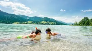 Zwei Kinder schnorcheln in einem See
