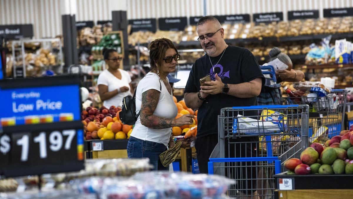 FILE - Shoppers pause in the produce section at a Walmart Superstore in Secaucus, New Jersey, July 11, 2024. (AP Photo/Eduardo Munoz Alvarez, File)