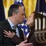 FILE - Vice President Kamala Harris and second gentleman Doug Emhoff kiss during an event in the East Room of the White House in Washington, to light the menorah to celebrate Hanukkah, Dec. 1, 2021. Republican presidential candidate former President Donald Trump in an interview on Tuesday claimed Vice President Kamala Harris “doesn’t like Jewish people,” despite being married to a Jewish man and Trump seemed to agree with a radio host who called second gentleman Doug Emhoff “a crappy Jew.” (AP Photo/Susan Walsh, File)