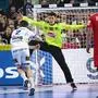 Iceland's right winger #02 Odinn Rikhardsson tries to score past Austria's goalkeeper #98 Constantin Moestl during the Men's EURO 2024 EHF Handball European Championship main round match between Austria and Iceland in Cologne, western Germany on January 24, 2024. (Photo by INA FASSBENDER / AFP)