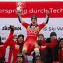 Switzerland's Marco Odermatt celebrates with the team after winning an alpine ski, men's World Cup giant slalom, in Alta Badia, Italy, Sunday, Dec. 22, 2024. (AP Photo/Alessandro Trovati)