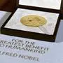 FILE - The Nobel diploma and medal in physiology or medicine is displayed, Tuesday, Dec. 8, 2020, during a ceremony in New York. (Angela Weiss/Pool Photo via AP, File)