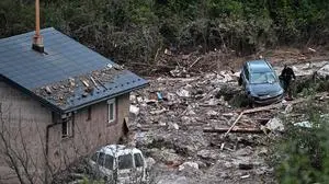 TOPSHOT - Photo taken in village of Donja Jablanica, about 50 kilometres south-west of Sarajevo on October 6, 2024, shows a man walking after mud, boulders and debris were cleared following a landslide that hit the village due to heavy rains on October 4. The search for dozens of people reported missing in floods that have claimed at least 17 lives in Bosnia continued on October 6, after torrential rains inundated towns and triggered landslides. (Photo by ELVIS BARUKCIC / AFP)