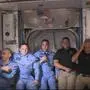 This NASA video frame grab image shows NASA SpaceX?s Crew Dragon astronauts Douglas Hurley(R) and Robert Behnken(2ndR) arriving after the hatch opened to the International Space Station posing with other astronauts on May 31, 2020. - US astronauts on a SpaceX Crew Dragon capsule were completing final close out procedures before entering the International Space Station after the hatch was opened between the two vessels. The hatch opened at 1:02 pm Eastern Time (1702 GMT) as Bob Behnken and Doug Hurley were poised to cross over into the station, the first US astronauts to arrive on an American spacecraft in nine years. (Photo by Handout / NASA TV / AFP) / RESTRICTED TO EDITORIAL USE - MANDATORY CREDIT "AFP PHOTO /NASA TV/HANDOUT " - NO MARKETING - NO ADVERTISING CAMPAIGNS - DISTRIBUTED AS A SERVICE TO CLIENTS