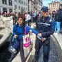 A photo taken and issued as a handout on April 1, 2023 by environmental activists of Last Generation (Ultima Generazione) shows a municipal policeman detaining a group's activist at the Barcaccia Fountain at Piazza di Spagna in Rome's historic centre, after the activists poured black liquid made out of vegetable-based carbon into the water as part of a campaign to raise awareness about climate change. (Photo by Handout / LAST GENERATION / AFP) / RESTRICTED TO EDITORIAL USE - MANDATORY CREDIT "AFP PHOTO /  LAST GENERATION / HANDOUT  " - NO MARKETING NO ADVERTISING CAMPAIGNS - DISTRIBUTED AS A SERVICE TO CLIENTS