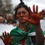 TOPSHOT - An activist takes part in a protest called by intellectuals and artists against the destruction of the Amazon rainforest, at Ipanema Beach in Rio de Janeiro, Brazil, on August 25, 2019. - Brazil on Sunday deployed two C-130 Hercules aircraft to douse fires devouring parts of the Amazon rainforest, as hundreds of new blazes were ignited ahead of nationwide protests over the destruction. More than half of the 79,513 fires recorded in Brazil this year are in the Amazon. (Photo by Mauro PIMENTEL / AFP)