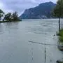 Nago-Torbole, Lake Garda, Italy - June 23, 2024: Volumes of water flow from the Sarca River into Lake Garda in the northern vacation resort of Torbole after persistent rainfall and storms. Lake has a high water level *** Wassermengen fließen im nördlichen Urlaubsort Torbole vom Fluss Sarca nach anhaltenden Regenfällen und Unwetter in den Gardasee. See hat hohen Pegelstand