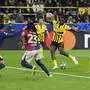 Dortmund's Serhou Guirassy, right, scores his side's third goal during the Champions League quarterfinals second leg soccer match between Borussia Dortmund and Barcelona, at the Signa-Iduna Park in Dortmund, Germany, Tuesday, April 15, 2025. (AP Photo/Martin Meissner)
