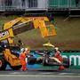 Marshals remove the car of McLaren's Australian driver Oscar Piastri after a crash during the sprint of the Sao Paulo Formula One Grand Prix at the Jose Carlos Pace racetrack, aka Interlagos, in Sao Paulo, Brazil on November 8, 2025. (Photo by Miguel SCHINCARIOL / AFP)