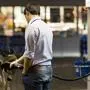 Young man fueling his car at the gas station