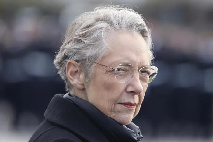 FILE - French Prime Minister Elisabeth Borne looks on as she attends a ceremony at the Arc de Triomphe, as part of the commemorations marking the105th anniversary of the Nov. 11, 1918 Armistice, ending World War I, Saturday, Nov. 11, 2023 in Paris. French President Emmanuel Macron on Monday Jan.8, 2024 accepted the resignation of Prime Minister Elisabeth Borne, the president's office said. Borne's resignation follows recent political tensions over a contentious immigration bill backed by Macron that would strengthen the government's ability to deport some foreigners, among other measures.(Ludovic Marin/Pool via AP, File)