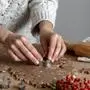Crop hands of faceless woman making gingerbread cookies with tin form in shape of star in kitchen Copyright: xLeirexGamboax