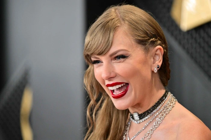 (FILES) US singer-songwriter Taylor Swift arrives for the 66th Annual Grammy Awards at the Crypto.com Arena in Los Angeles on February 4, 2024. Swift was officially named a member of the three-comma-club on April 2, 2024, as Forbes confirmed rumors estimating her wealth exceeds a billion dollars. (Photo by Robyn BECK / AFP)