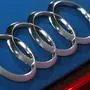 FILE - In this file photo dated Thursday, March 14, 2019, the logo of the German car manufacturer Audi is pictured on a Audi e-tron prior to the annual press conference in Ingolstadt, Germany. The Ingolstadt-based automaker said Tuesday Nov. 26, 2019, that it expected to add 2,000 new positions while Volkswagen subsidiary Audi says it is cutting 9,500 jobs in Germany through 2025. (AP Photo/Matthias Schrader, FILE)