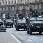 TOPSHOT - Ukrainian military vehicles move past Independence square in central Kyiv on February 24, 2022. - Air raid sirens rang out in downtown Kyiv today as cities across Ukraine were hit with what Ukrainian officials said were Russian missile strikes and artillery. Russian President announced a military operation in Ukraine on February 24, 2022, with explosions heard soon after across the country and its foreign minister warning a "full-scale invasion" was underway. (Photo by Daniel LEAL / AFP)