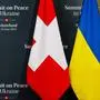This photograph taken on June 15, 2024, shows Switzerland and Ukrainian flags at the media centre during the final preparations for a Summit on Peace in Ukraine at the luxury Burgenstock resort, central Switzerland. The two-day gathering brings together Ukrainian President and more than 50 other heads of state and government, to try to work out a way towards a peace process for Ukraine -- albeit without Russia. (Photo by Dimitar DILKOFF / AFP)