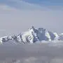 A photo taken on October 12, 2024 from the Sonnblick Observatory near Rauris, Austria, shows the Grossglockner, with 3798 metres Austria's highest mountain, in the Hohe Tauern mountain range. Experts say warmer temperatures across the Alps driven by climate change are accelerating glacier melt and thawing permafrost -- the year-round ice found at high altitude that binds together giant slabs of rock. This has increased the danger of sudden rockfalls and landslides, damaging paths and adding stress to the mountains' often-ageing huts. Austria's Alpine clubs are currently closing up to four huts a year as they have become unsafe or too costly to be maintained. (Photo by KERSTIN JOENSSON / AFP)