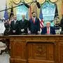 US President Donald Trump makes a trade announcement as US Secretary of Commerce Howard Lutnick (2L), US Vice President JD Vance (3L), and British ambassador to the United States Peter Mandelson (3R), look on in the Oval Office of the White House in Washington, DC, on May 8, 2025. US President Donald Trump on announced a "full and comprehensive" trade agreement with Britain, which would be the first such deal since he launched his global tariffs blitz. (Photo by Jim WATSON / AFP)
