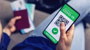 vaccinated person using digital health passport app in mobile phone for travel during covid-19 pandemic