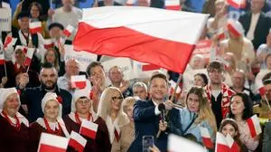 TOPSHOT - Rafal Trzaskowski, Presidential candidate, Warsaw's mayor and member of Poland’s ruling Civic Coalition party, waves the Polish flag as he speaks to supporters after first exit polls following Presidential elections are announced in Sandomierz, on May 18, 2025. (Photo by Wojtek RADWANSKI / AFP)