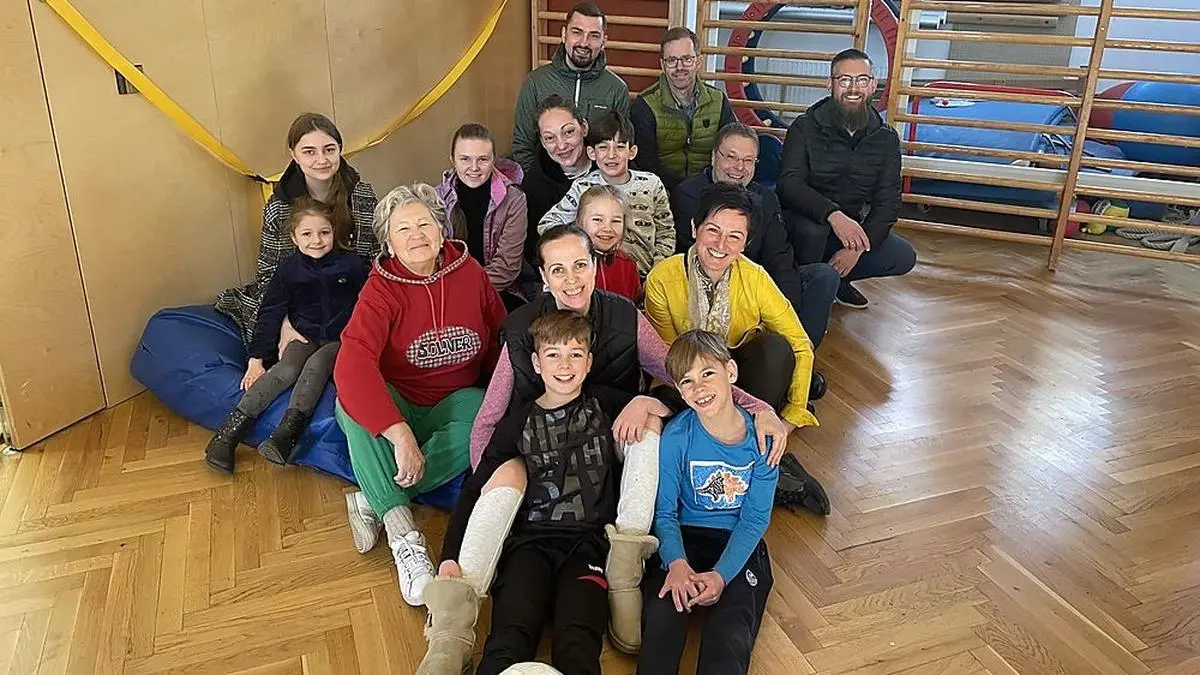 Der Turnsaal in St. Johann ist wieder voller Leben - am Bild drei Flüchtlingsfamilien mit den Gemeindevertretern