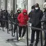 People queue outside the Nike Town store at Oxford Circus as non-essential shops in England open their doors to customers for the first time after the second national lockdown ends and England has a strengthened tiered system of regional coronavirus restrictions, in London, Wednesday Dec. 2, 2020. (Kirsty O'Connor/PA via AP)
