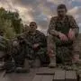 TOPSHOT - Ukrainian tank crew take a break while operating a Soviet-made T-72 tank in the Sumy region, near the border with Russia, on August 12, 2024, amid the Russian invasion of Ukraine. Ukraine launched a surprise offensive into the Russian border region of Kursk on August 6, 2024, capturing over two dozen towns and villages in the most significant cross-border attack on Russian soil since World War II. Ukraine's military chief Oleksandr Syrsky told President Volodymyr Zelensky in a video posted on August 12, 2024 that his troops now control about 1,000 square kilometres of Russian territory and are continuing "offensive operations". (Photo by Roman PILIPEY / AFP)